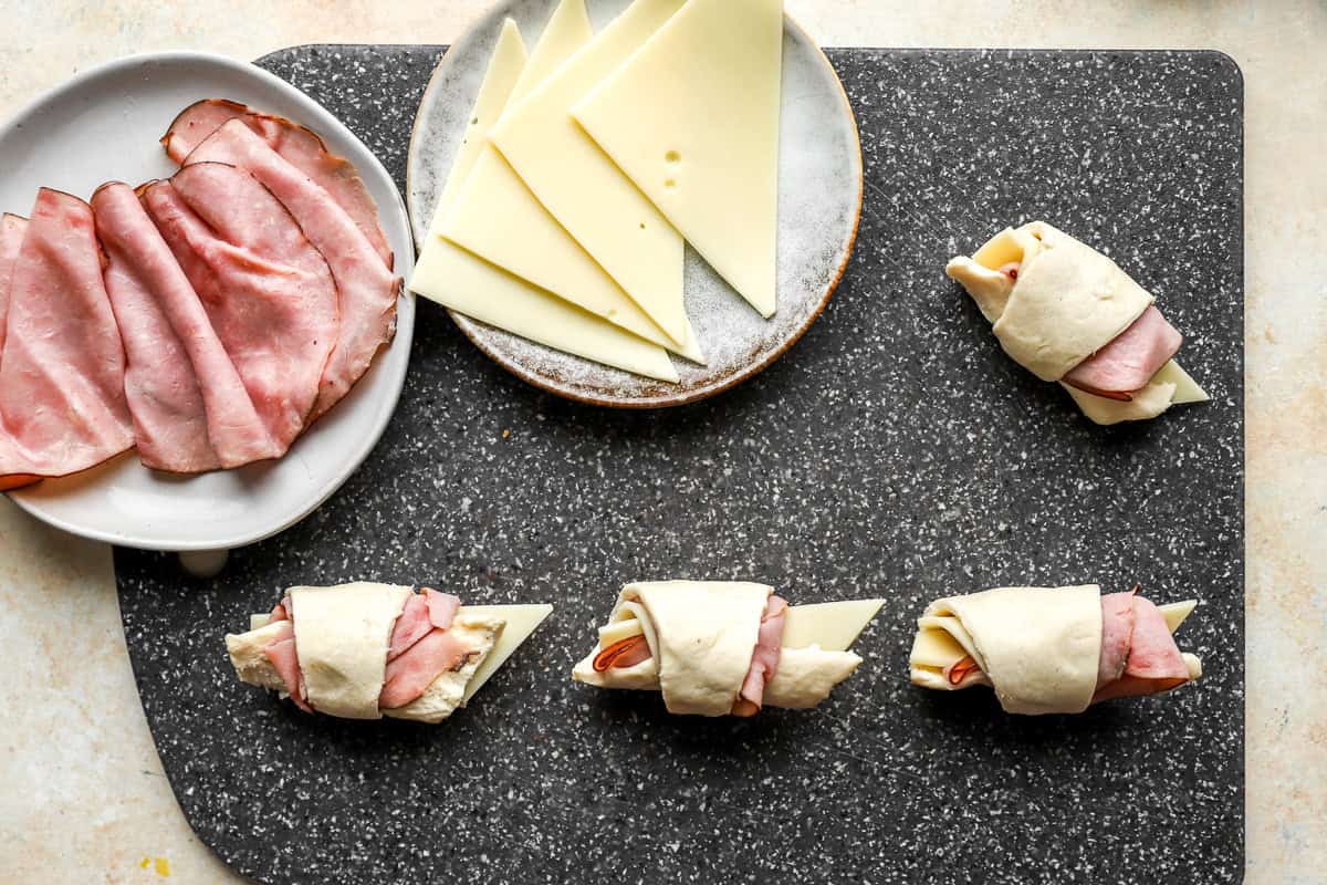ham and cheese croissants getting rolled up