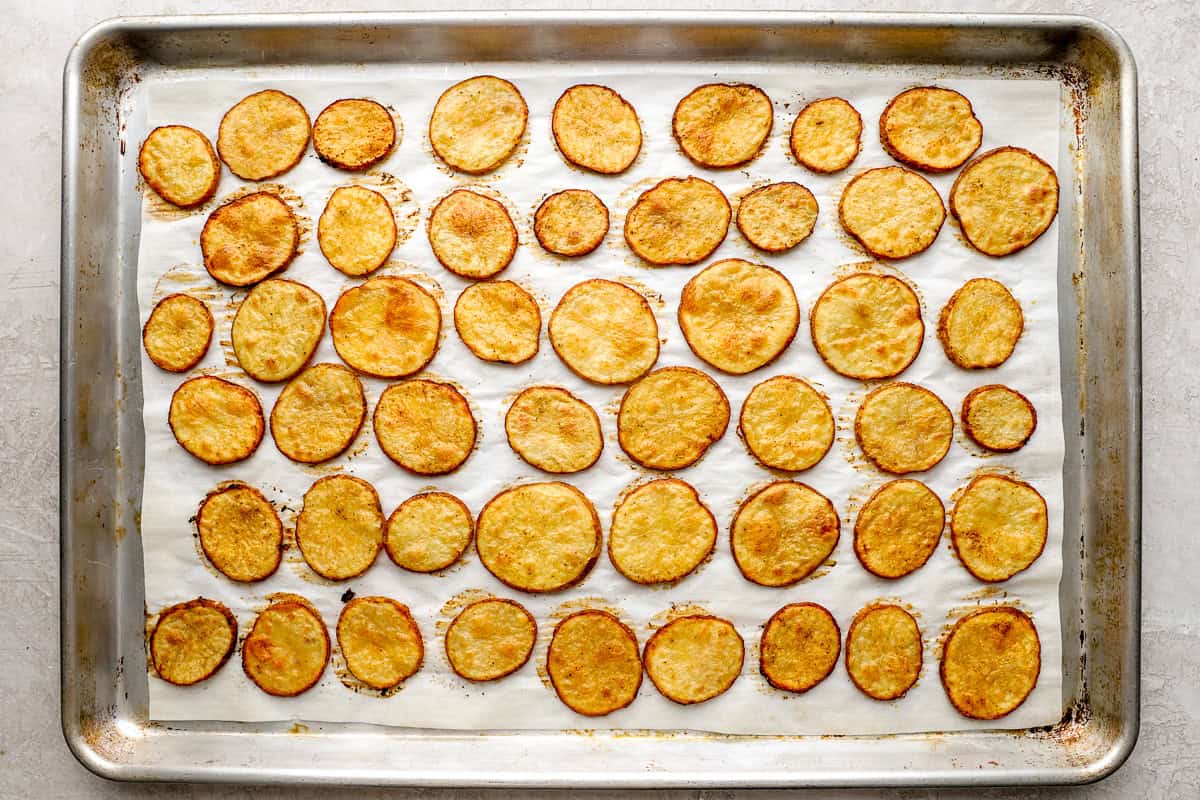 Golden brown cottage fries with crispy edges baked on a parchment-lined sheet pan.