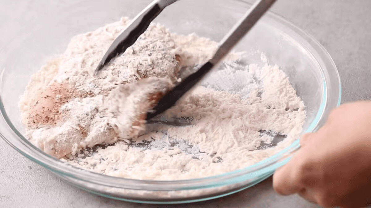 dredging chicken in flour and Parmesan cheese