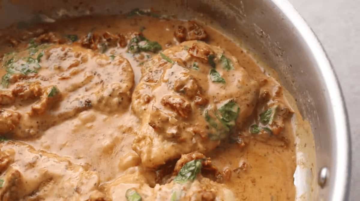 chicken simmering in skillet