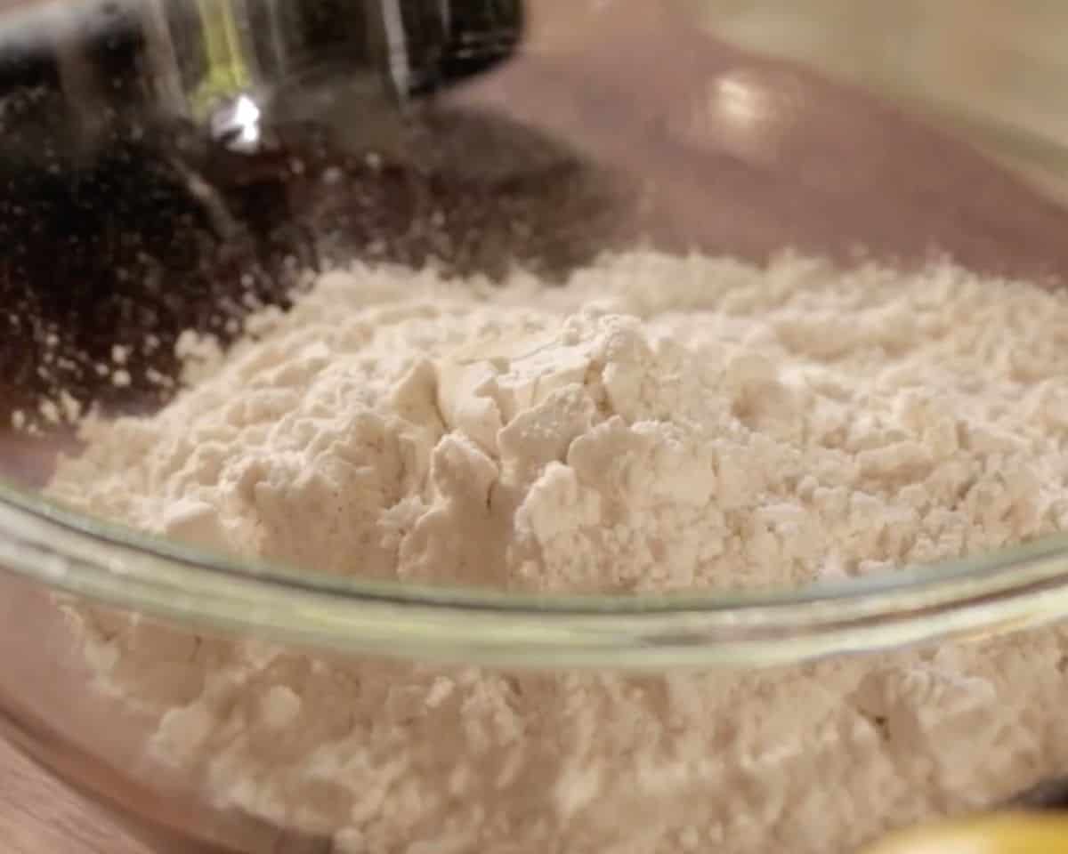 Dry ingredients in glass mixing bowl for lemon bar crust