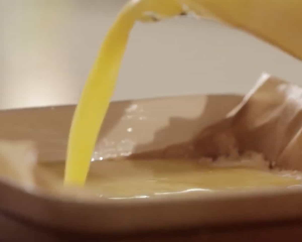 Pouring lemon filling over baked gluten-free shortbread crust