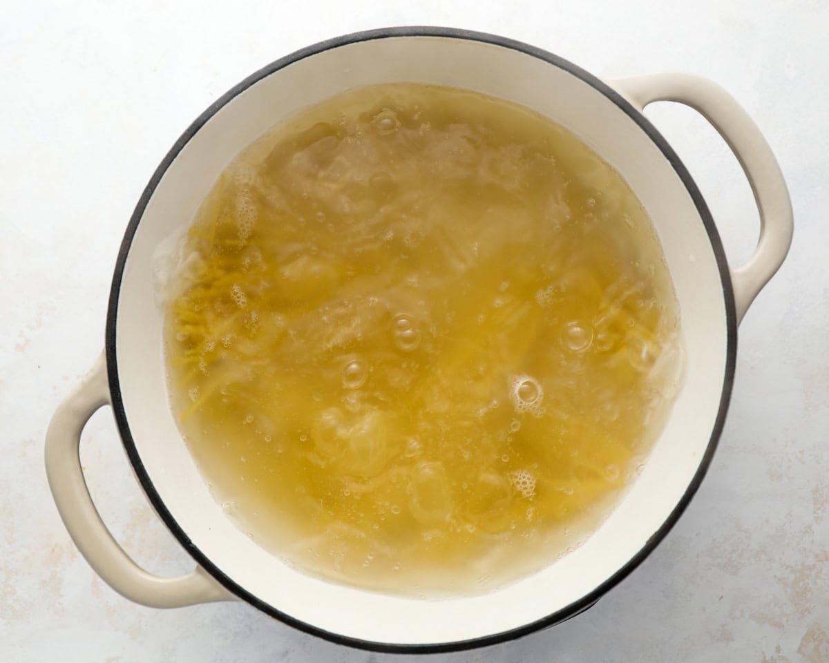 Spaghetti boiling in a pot of salted water during the cooking process