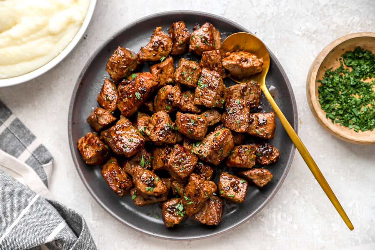 finished garlic butter steak bites on a plate