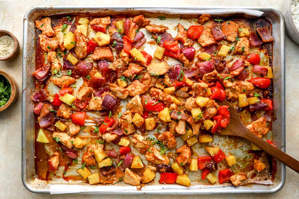 Baked sheet pan Hawaiian chicken with pineapple, peppers, and onions caramelized