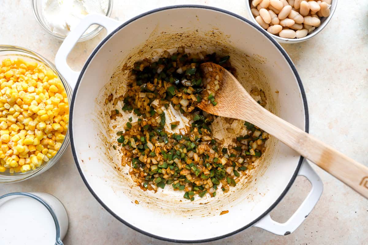 Chopped onion and jalapeños sautéing in a Dutch oven until softened and fragrant