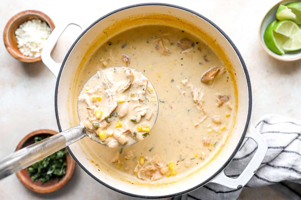 Creamy street corn white chicken chili in a Dutch oven with shredded chicken, corn, and white beans