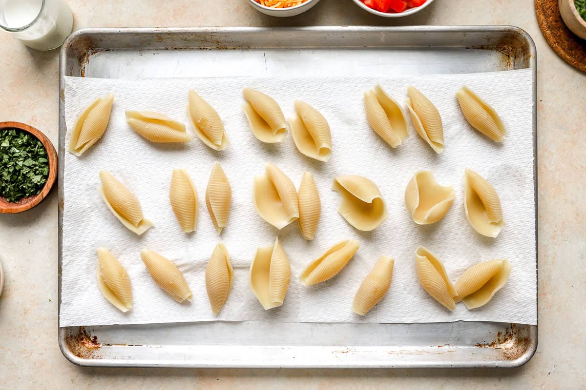 Jumbo pasta shells filled with taco beef mixture arranged in a casserole dish