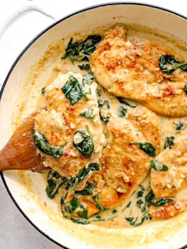 Creamy chicken florentine in a skillet with golden seared chicken, spinach, and parmesan cream sauce