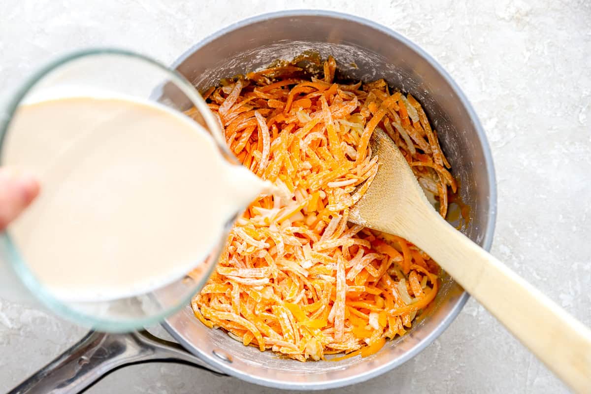 pouring milk into pot of nacho cheese sauce