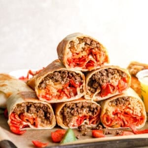 Stack of sliced Flamin’ Hot grilled cheese burritos filled with seasoned beef, taco rice, melted cheese, and Flamin’ Hot Fritos.