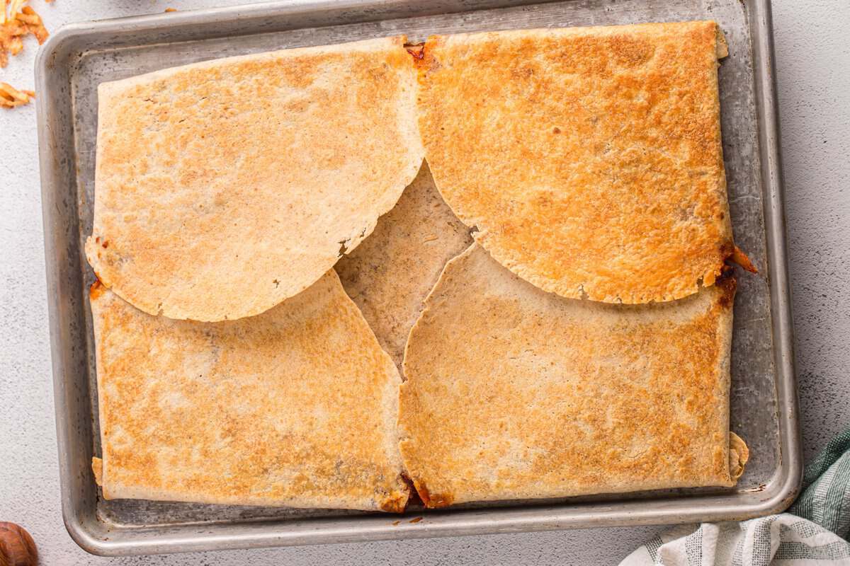 Baked sheet pan BBQ chicken crunchwrap with a golden brown crispy tortilla crust fresh from the oven.