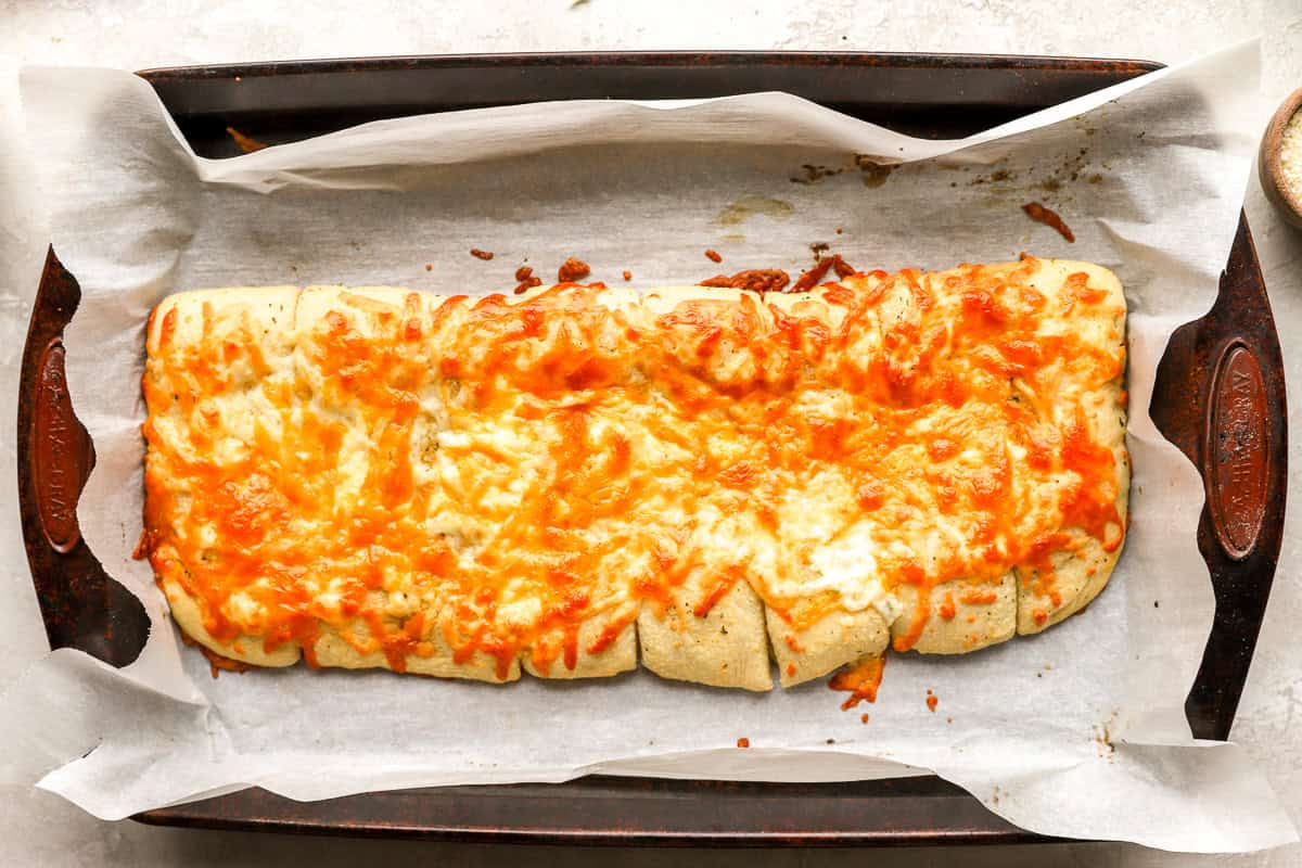 Baked stuffed cheesy bread fresh out of the oven with golden, bubbly melted cheese on top