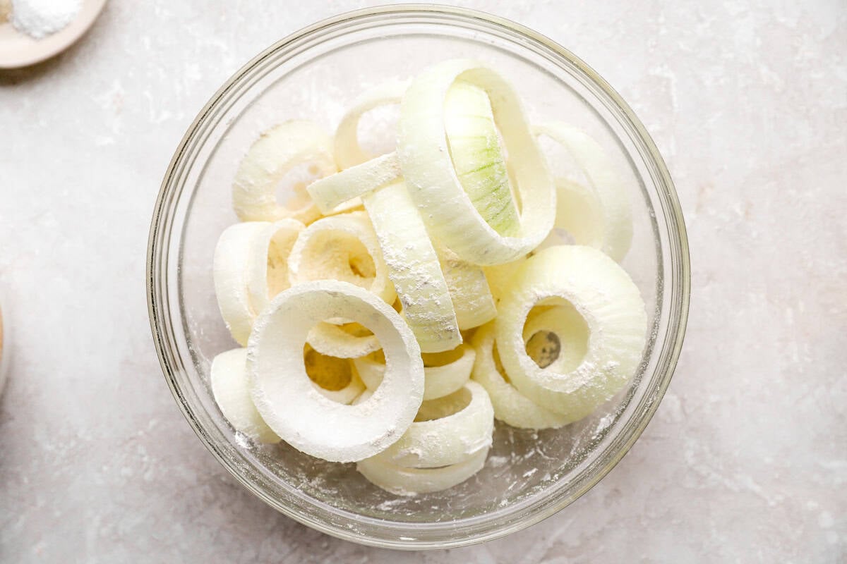 sliced onions in a bowl, sliced into rings