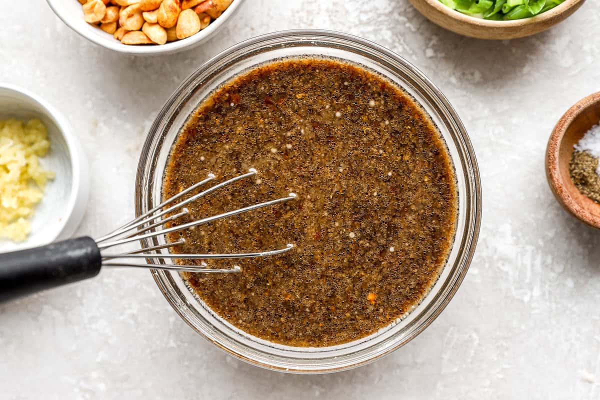 Kung pao spaghetti sauce being whisked together in a glass bowl before cooking