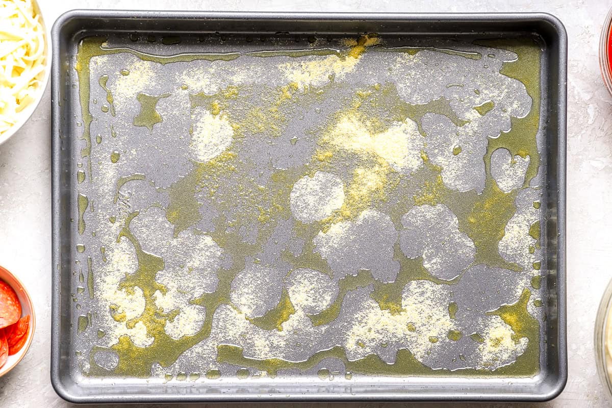 Empty sheet pan brushed with olive oil and dusted with cornmeal before adding the dough