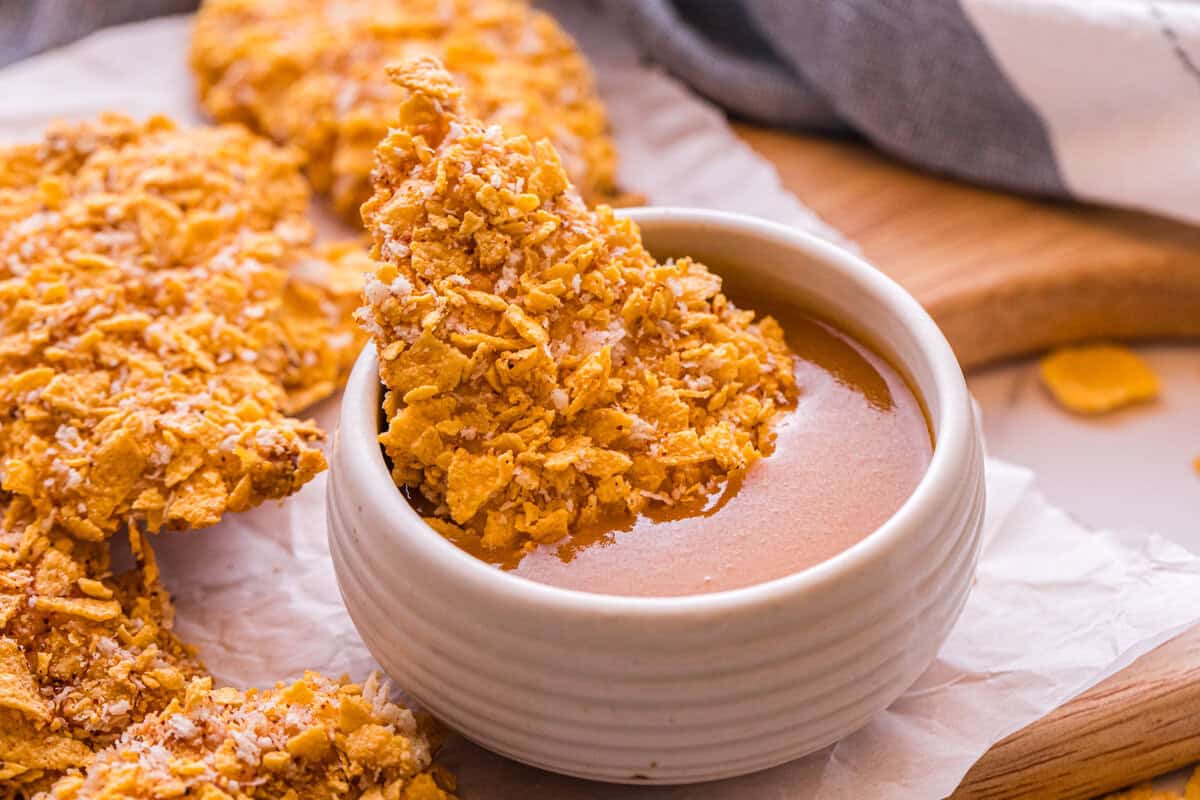 buffalo chicken tender dipped in sauce